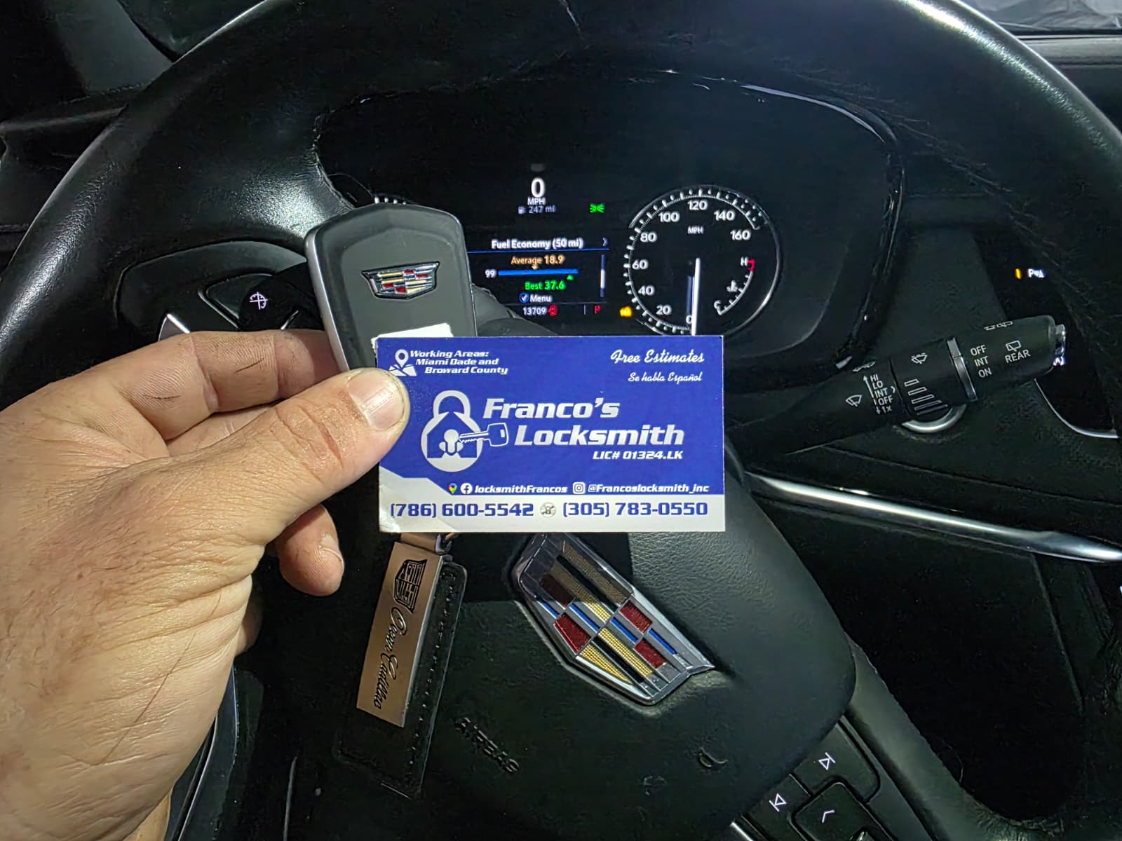 A replacement key with Franco’s Locksmith card inside a Cadillac