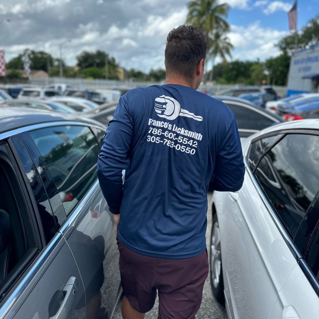 Franco beside vehicles during mobile locksmith work